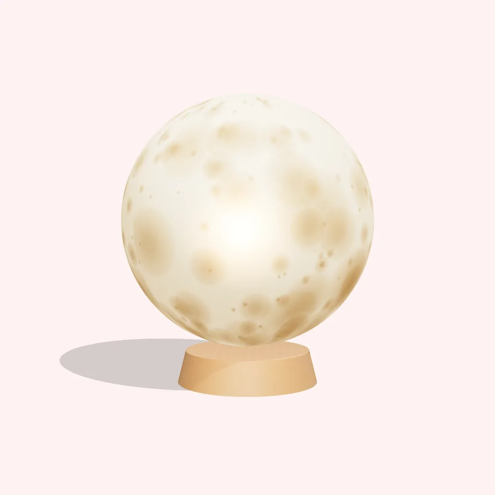 Lámpara luna encendida sobre una base de madera
